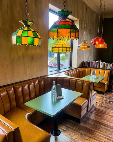 Booth seating under stained-glass pendant lamps